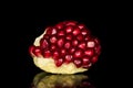 Fresh red pomergranate isolated on black glass Royalty Free Stock Photo