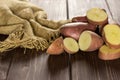 Fresh red potato francelina on brown wood Royalty Free Stock Photo