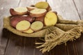 Fresh red potato francelina on brown wood Royalty Free Stock Photo