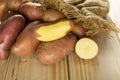 Fresh red potato francelina on natural wood Royalty Free Stock Photo