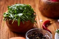 Fresh red radish in wooden bowl among plates with vegetables, herbs and spicies, top view, selective focus. Royalty Free Stock Photo