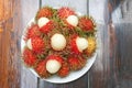 Fresh red rambutan in white plate Royalty Free Stock Photo