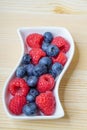 Fresh red raspberries and blueberries, still life, closeup and detail view Royalty Free Stock Photo