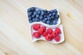 Fresh red raspberries and blueberries, still life, closeup and detail view Royalty Free Stock Photo