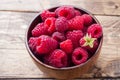 Fresh red raspberry berries in a wooden plate Royalty Free Stock Photo