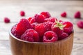 Fresh red raspberry berries in a wooden plate Royalty Free Stock Photo