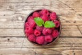 Fresh red raspberry berries in a wooden plate Royalty Free Stock Photo