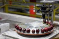 Fresh red ripe cherries on a turntable pressure tester at a packing warehouse Royalty Free Stock Photo