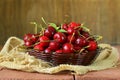 Fresh red ripe cherries in wicker basket Royalty Free Stock Photo