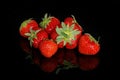 Fresh red ripe strawberries on a black background