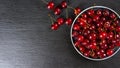 Fresh red ripe sweet cherry with water drops on plate on black slate background. Royalty Free Stock Photo