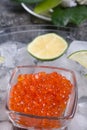 Fresh red salmon caviar with lime around ice. macro shot. Protein luxury delicacy healthy food