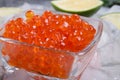 Fresh red salmon caviar with lime around ice. macro shot. Protein luxury delicacy healthy food