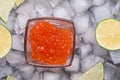 Fresh red salmon caviar with lime around ice. macro shot. Protein luxury delicacy healthy food. flat lay