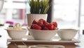 Fresh red strawberries with cream om white wood table. Easy diet