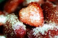 Fresh red strawberries with a cut one in the middle. Covered in sugar Royalty Free Stock Photo