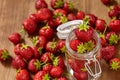 Fresh red strawberries for jam in a glass jar on the brown wooden table. Royalty Free Stock Photo