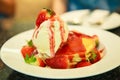 Fresh red strawberries topping vanilla ice cream on pancake seasoned with strawberry sauce. Healthy sweet dessert, Food Royalty Free Stock Photo