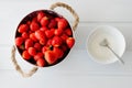 Fresh red strawberries in white bowl and sugarbowl Royalty Free Stock Photo