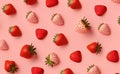 Fresh red strawberry on pink background, top view. Minimalistic scattered berries pattern