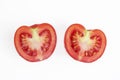 Fresh red tomato cut into two halves, with water drops, isolated on a white background. Royalty Free Stock Photo