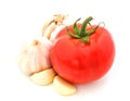 Fresh red tomato with garlic isolated on white background.