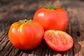 Fresh red tomato on old brown wood table at the morning Royalty Free Stock Photo