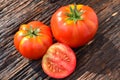 Fresh red tomato on old brown wood table at the morning Royalty Free Stock Photo