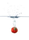 Fresh Red Tomato Sinking in Water Royalty Free Stock Photo