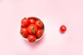 Fresh red tomatoes in a bowl on a pink background Royalty Free Stock Photo
