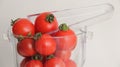 Fresh red tomatoes cherry in a glass bowl isolated on white Royalty Free Stock Photo