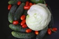 Fresh red tomatoes, cucumbers, green paperika and iceberg lettuce on the serving tray. Royalty Free Stock Photo