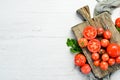 Fresh red tomatoes on white wooden background. Greens. Top view. Royalty Free Stock Photo