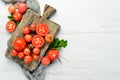 Fresh red tomatoes on white wooden background. Greens. Top view Royalty Free Stock Photo