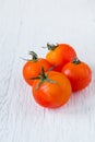 Fresh red tomatoes on white wooden table Royalty Free Stock Photo