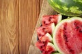 Fresh red watermelon pieces on a black plate on a wooden table. Sweet and juicy watermelon Royalty Free Stock Photo