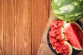 Fresh red watermelon pieces on a black plate on a wooden table. Sweet and juicy watermelon Royalty Free Stock Photo