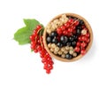 Fresh red, white and black currants in bowl with green leaf isolated on white, top view Royalty Free Stock Photo