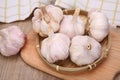 Fresh red and white garlic on wooden board.