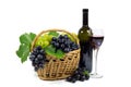 Fresh Red and White Grapes with Green Leaves in Wicker Basket, Wine Glass Cup and Wine Bottle Filled with Red Wine Isolated Royalty Free Stock Photo