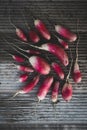 Fresh red radishes in a group on wood background