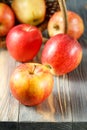 Fresh red yellow apples Gala falling from wicker basket on wooden table Royalty Free Stock Photo