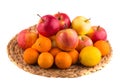 Fresh red and yellow apples, tangerines and lemons in a wooden basket