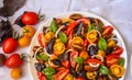 Top view of Fresh red & yellow cherry tomato salad and green and red basil leaves Royalty Free Stock Photo