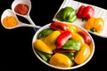 Fresh red,yellow and green capsicum slices also called bell pepper isolated on a black background. Royalty Free Stock Photo