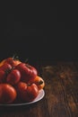 Fresh red and yellow tomatoes on plate Royalty Free Stock Photo