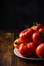 Fresh red and yellow tomatoes on plate Royalty Free Stock Photo