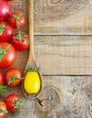 Fresh red and yellow tomatoes on wooden background Royalty Free Stock Photo