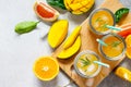 Fresh refreshing summer drinks. Multifruit drinks of citrus and mango with ice, smoothies