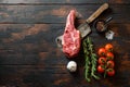Fresh Ribeye Steak, Bone-In  steak cut on meat cleaver. Organic farm marbled prime black angus beef. Dark wooden background. Top Royalty Free Stock Photo
